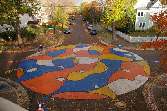 Street Art on the pavement of a traffic circle.